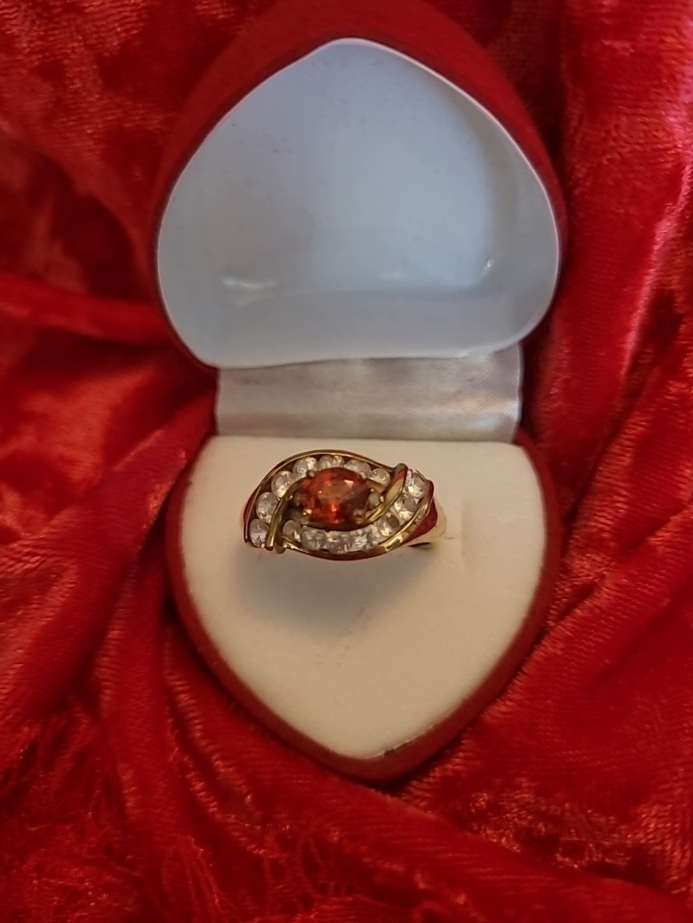 1.25ct. Spessartite Garnet Surrounded By 14 Sparkling Diamonds!